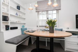 a small kitchen with a table and a bench at Haus-Friesenperle in Westerland