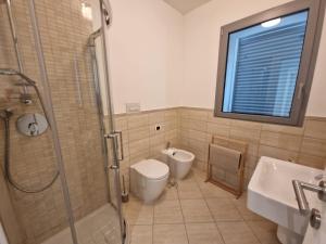 a bathroom with a shower and a toilet and a sink at Il Rifugio di Boccadasse in Genoa +12 photos