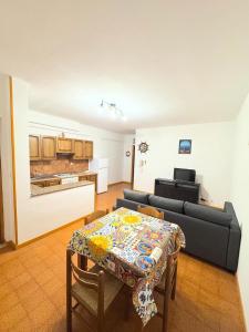 a living room with a table and a couch at A montagna e u mari home in Aci Castello +13 photos