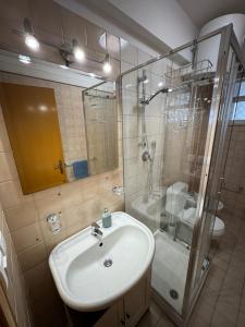 a bathroom with a sink and a shower at A montagna e u mari home in Aci Castello