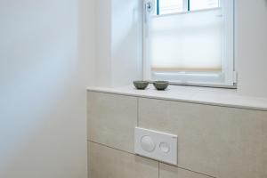 two bowls on a counter in a kitchen with a window at Stadtrose in Westerland