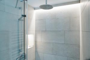 a bathroom with a shower with a glass door at Stadtrose in Westerland +13 photos
