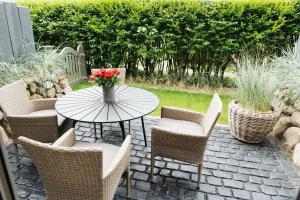 a table with a vase of flowers on a patio at Stadtrose in Westerland