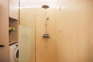 a shower in a bathroom with a glass door at BLUE WAVE by Design Studio in Bellano