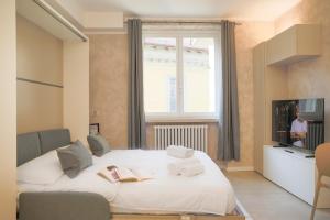 a bedroom with a bed with two books on it at BLUE WAVE by Design Studio in Bellano