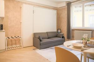 a living room with a couch and a table at BLUE WAVE by Design Studio in Bellano +12 photos