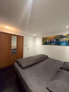 a bedroom with a bed and a painting on the wall at Red House 12 in Ban Nong Pru
