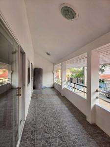 an empty hallway of a house with windows at Red House 12 in Ban Nong Pru