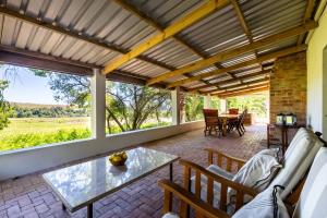 an outdoor living room with a table and chairs at Florie se Huis in Paarl