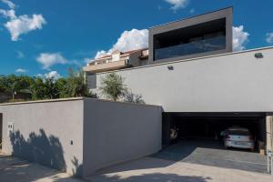 a garage with a car parked inside of it at Luxury Villa Black Cube with Heated pool in Mlini