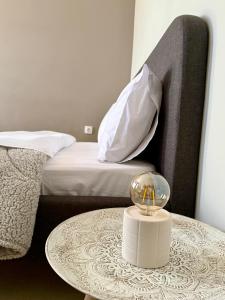 a table with a glass bowl on top of it next to a bed at Sunny apartment in Serres