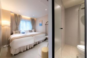 a bedroom with two beds and a shower at 4rest Stay Euljiro in Seoul +79 photos