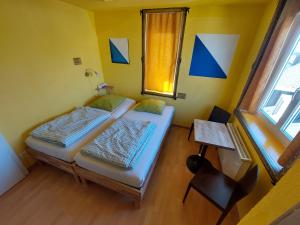 a small room with two beds and a window at Oldtown Hostel Otter in Zurich