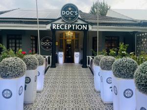 a dog reception building with potted plants in front of it at Halfway House Hotel in Kimberley +113 photos