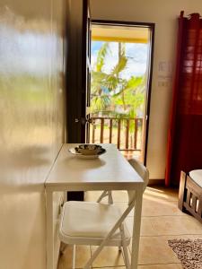 a table and a chair in a room with a window at Lavajas Guest House in San Juan