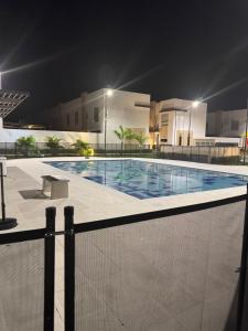 a swimming pool at night in front of a building at Casa Bethel 92 in Ricaurte
