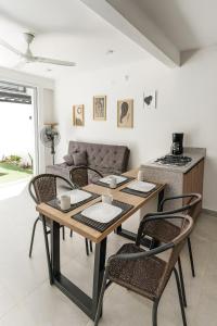 a living room with a table and chairs and a couch at Casa Bethel 92 in Ricaurte
