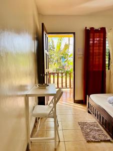 a bedroom with a desk and a bed and a table at Lavajas Guest House in San Juan