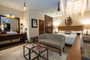 a bedroom with a bed and a bathroom with a sink at Casa Mia Suites in San Miguel de Allende
