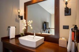 a bathroom with a sink and a large mirror at Casa Mia Suites in San Miguel de Allende +108 photos
