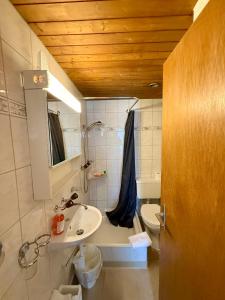 a bathroom with a sink and a toilet at Downtown Apartments in Interlaken +45 photos