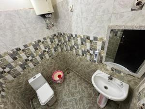 a bathroom with a sink and a toilet and a mirror at Fun N Forest Resort in Dehradun +27 photos