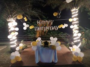 a birthday party with balloons and a happy birthday sign at Fun N Forest Resort in Dehradun