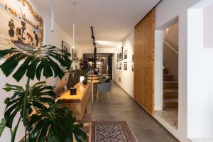 a living room with a potted plant and a staircase at O VIOLAS - Art Coffee & Guesthouse in Praia de Mira