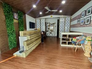a living room with a wall with ivy at Lotus Beach Resort in Nagaon