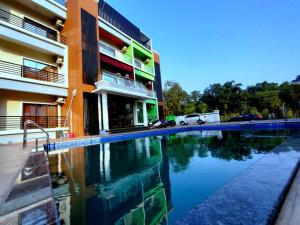 a swimming pool in front of a building at Lotus Beach Resort in Nagaon