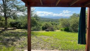 a view out of a window of a field at El Campito in Villa Icho Cruz