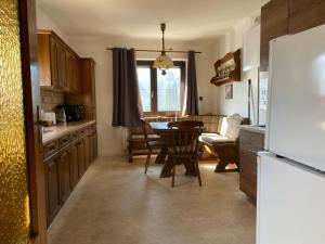 a kitchen with a table and a dining room at Apartmenthaus MITTERFELD in Mitterfeld