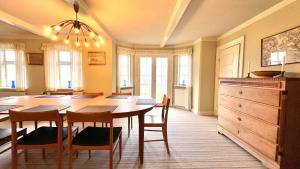 a dining room with a wooden table and chairs at Historic Farmhouse From 1848 in Hårby