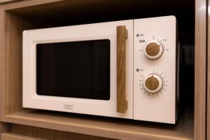 a microwave with a wooden stick sticking out of it at 4rest Stay Euljiro in Seoul