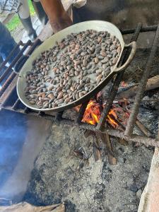 a pan full of beans cooking over a fire at Finca Las Palmas Ecolodge in Puyo