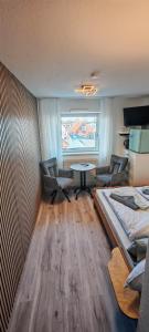 a room with a bed and a table and chairs at Ankerplatz in Travemünde