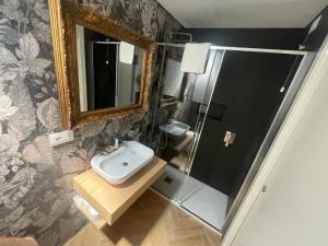 a bathroom with a sink and a mirror at Residence Cavour 63 in Ravenna +48 photos