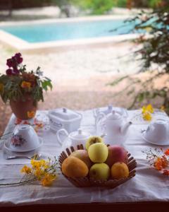a table with a bowl of fruit on top of it at Bandam Lodge in Ngaring