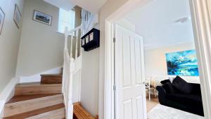 a white door leading to a living room with stairs at Baileys Beach House - Part of the The Bay Filey Holiday Village with pool, gym and direct beach access, pub, restaurant, tennis and meadows walks in Filey
