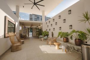 a lobby with chairs and plants in a building at Bali Hotel Adults Only Isla Verde, a Trademark by Wyndham in San Juan
