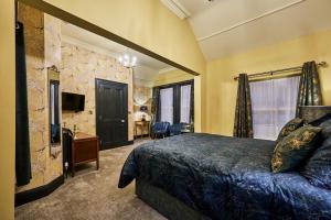 a bedroom with a bed and a television in a room at Jazz House in Derry Londonderry