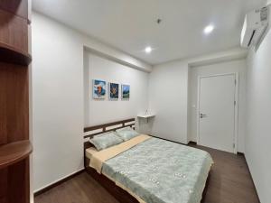 a bedroom with a bed in a white room at Youyi Home in Thuan An +14 photos