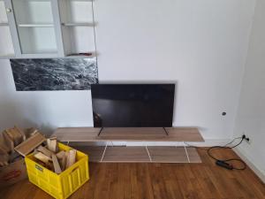 a living room with a flat screen tv on a table at Delblaiso Suite in Memmingen