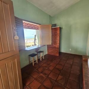 a room with a table and two stools and a window at Pousada Mae Natureza Icapuí in Icapuí +24 photos