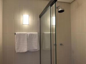 a bathroom with a shower and white towels at Heritage X in São Paulo +48 photos