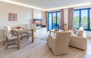 a living room with a table and a dining room at Princess in Binz