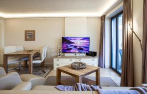 a living room with a tv and a table at Princess in Binz
