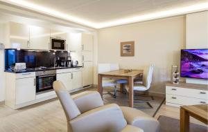 a kitchen with a table and a dining room at Princess in Binz