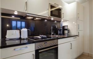 a kitchen with a sink and a stove top oven at Princess in Binz +33 photos