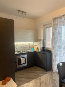 a kitchen with a sink and a stove top oven at Pella House in Airasca